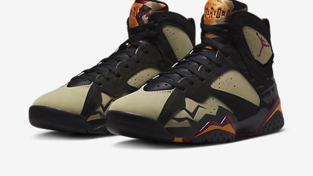 View of black and olive Air Jordan shoes.